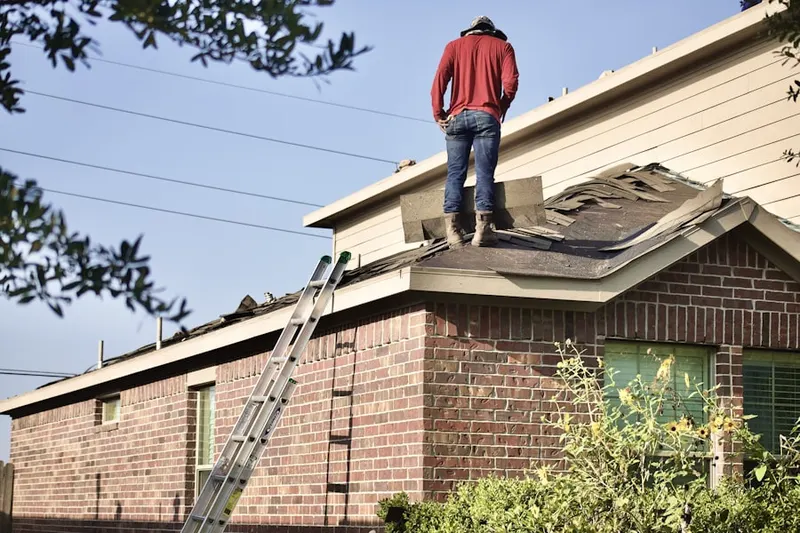 Professional roofer working on a residential roof in Somis